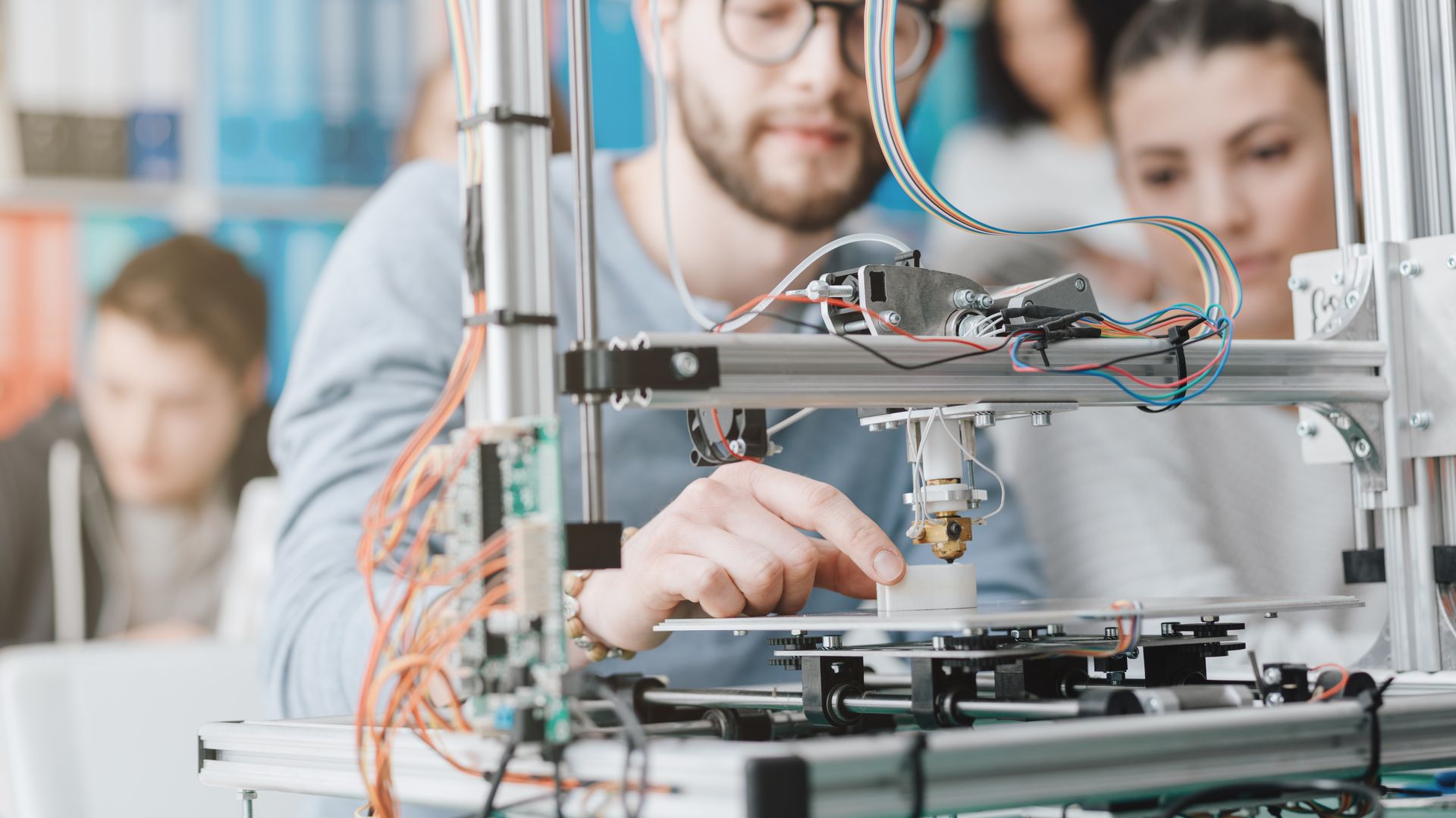 Engineers working together at a 3D printer
